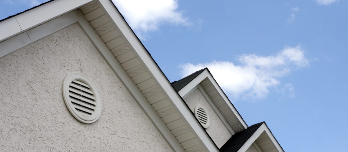 Close up of roof peaks against blue sky